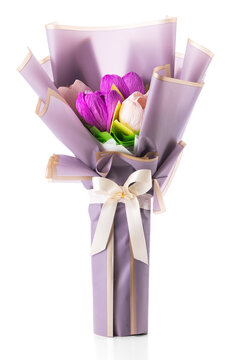 Handmade crepe paper flower bouquet wrapped in purple paper isolated on white background