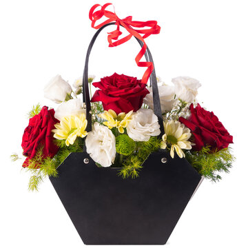 Red roses white eustoma and yellow chrysanthemums floral arrangement in black gift bag isolated on white background