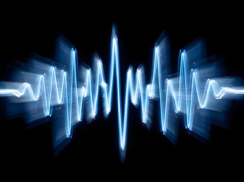 An abstract blue sound wave visual on a dark black background represents modern digital audio and advanced technology concepts