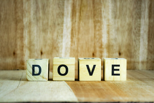 wooden alphabet letter blocks arranged on a rustic wooden background to spell various English words