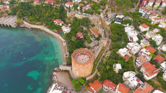 Alanya, Turkey. Kizilkule Red Tower, octagonal stone roof and historic harbor walls, top-down vertical drone view over turquoise Mediterranean waters. Aerial View, MasterShots, Rocket