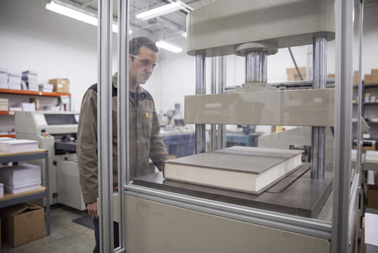 Bindery Worker Monitoring Hydraulic Book Press
