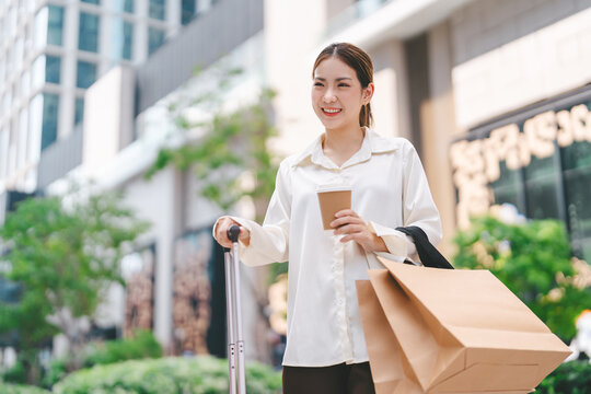 Single adult business asian woman confidence smiling holding coffee cup and shopping bag city people lifestyle