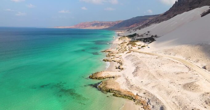 Rocky Coastline Above The Arher Massive Sand Dunes On Socotra Island In Yemen. Aerial Drone Shot