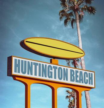 Aged Huntington Beach sign with surfboard and palm trees