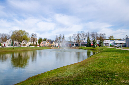 Calm river bend with sandbar birds and forest reflecting cloudy sky. Flowing quietly past sandbar, peaceful mood, riverside forest village, tranquil landscape nature concept