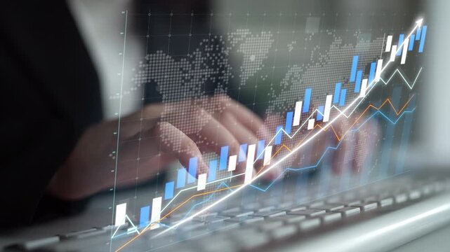 Close-up of a business professional reviewing financial data with digital graphs and charts on the screen, emphasizing market trends and growth insights. Copula