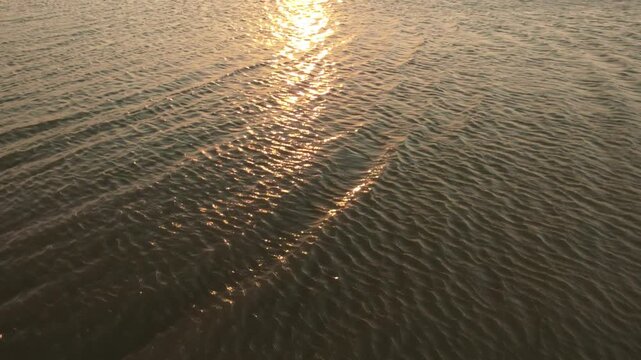 Golden Sunset Reflection on Water Surface