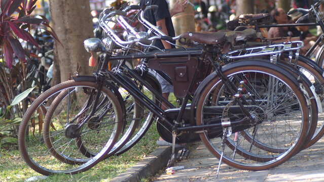 Row of Classic Vintage Onthel Bicycles Parked on the Roadside for Community Gathering