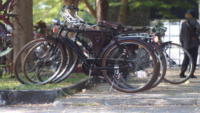 Row of Classic Vintage Onthel Bicycles Parked on the Roadside for Community Gathering