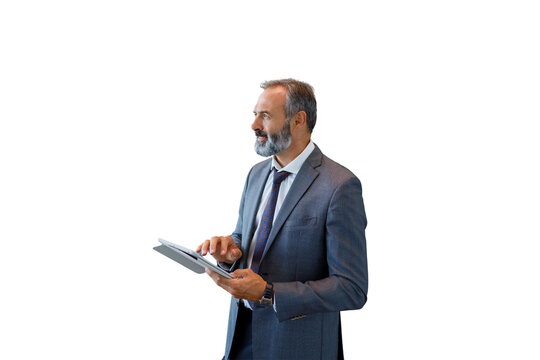 Mature businessman working with tablet looking away