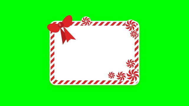 Decorative Christmas holiday frame with red bow and peppermint candies on green background.
