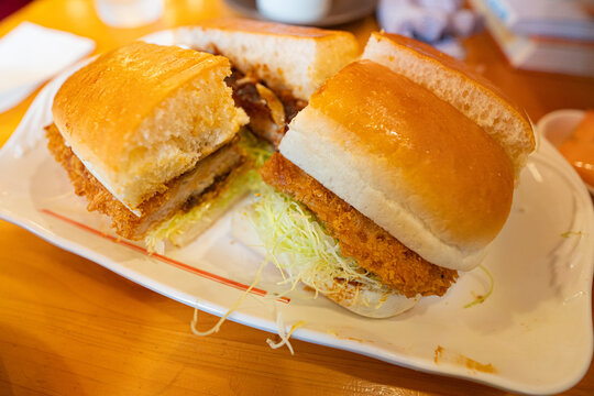 Japanese katsu sando pork cutlet sandwich with shredded cabbage on a plate