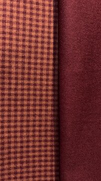 Vertical shot of elegant suit fabric rolls as camera tracks