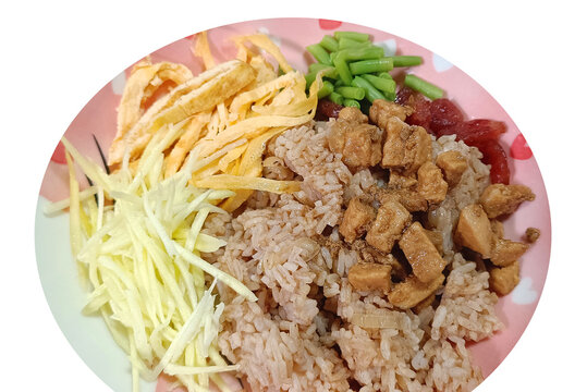 Traditional Thai Shrimp Paste Fried Rice, Known as Khao Kluk Kapi, Served with Sweet Pork, Shredded Green Mango, Omelet Strips, Fresh Vegetables, and Sweet and Savory Accompaniments. Thai dish.