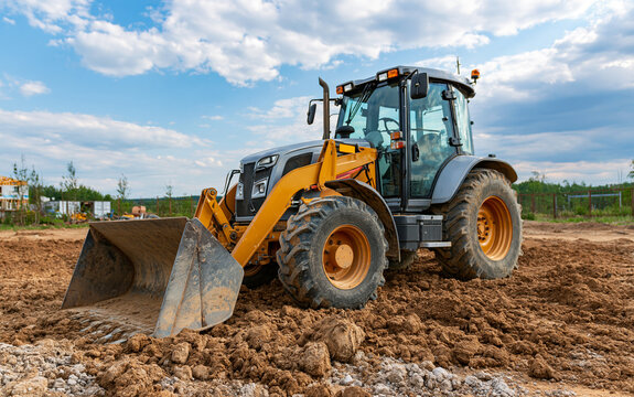Tractor with front loader at rural construction site