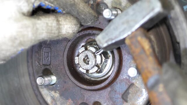 Removing Ball Joint Stud from Wheel Hub Using Pliers and Screwdriver, This close-up instructional video demonstrates how to safely remove a ball joint stud using pliers