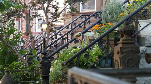 New York City townhouse buildings, brownstone row houses in Manhattan or Brooklyn, United States of America. Classic buildings on residential district street. Real estate property. Rowhouse townhome.