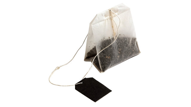 Single disposable paper tea bag with string label isolated on transparent background