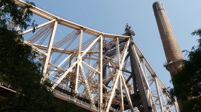 New York City Manhattan Midtown, Queensboro bridge architecture in United States. Urban transport bridge over East River. View from below, under metallic bridge in East Side near Roosevelt island.