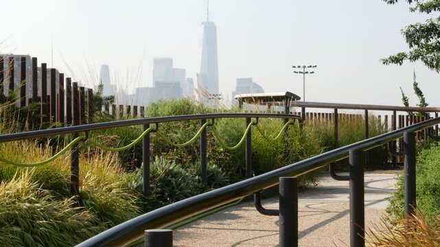 New York City downtown skyline and Little Island pier park in Midtown of Manhattan, United States. Financial district cityscape, world trade center and urban garden oasis on pillars in Chelsea, USA.