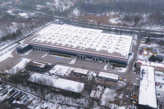 Modern warehouse roof seen in winter aerial