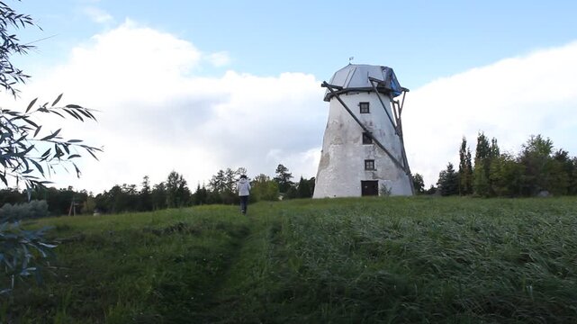 Woman Walking Toward Old Tower in Estonia

