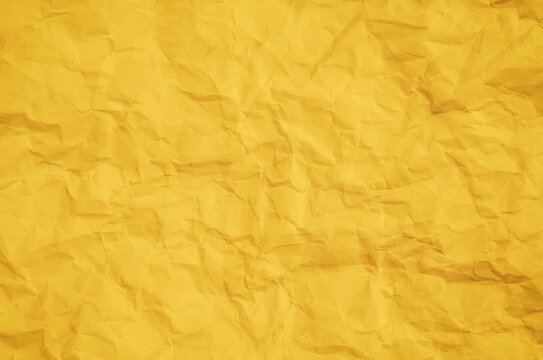 Crumpled yellow paper texture background with copy space. Concept of abstract background, creativity, idea generation, and vintage design.