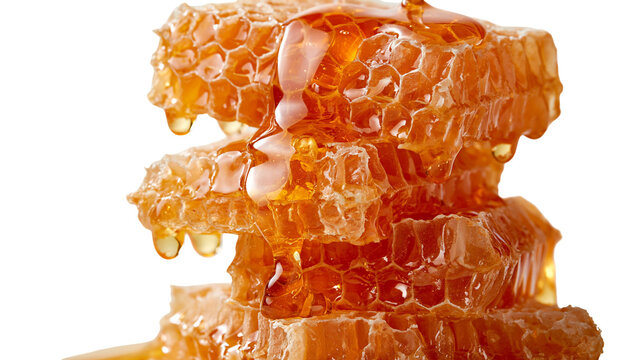 Stacked golden honeycomb pieces with dripping liquid honey