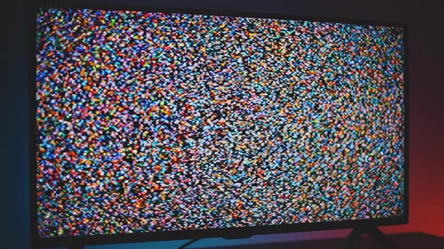 Digital Glitch Effect on Television Screens with Static and Distorted Human Figures during Broadcast Transmission