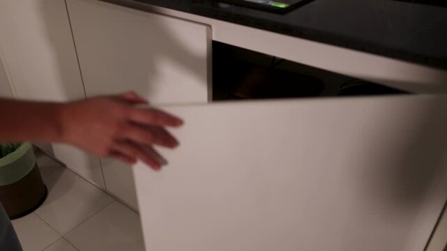 Opening Kitchen Cabinet and Taking Out Wooden Cutting Board