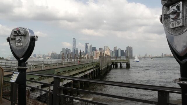 New York City Manhattan Downtown skyline from Liberty Island, United States. Financial District urban cityscape, World Trade Center skyscraper tower. Building architecture wooden pier and tower viewer