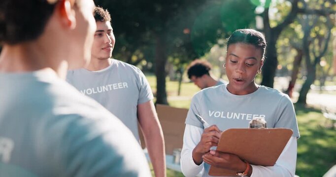 Team, leader and volunteer outdoor with meeting, charity briefing or task delegation with smile. People, motivation and clipboard with schedule or agenda for humanitarian aid or community outreach