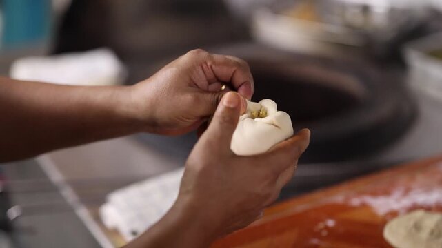 Chef Hands Stuffing Traditional Indian Bread Dough in Kitchen