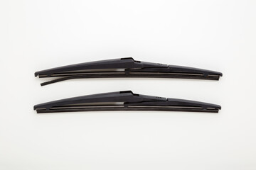 Obraz premium New and old car rear windshield wiper blades isolated on light gray table background. Closeup. Compare two objects. Car spare parts. Flat lay. Top down view.