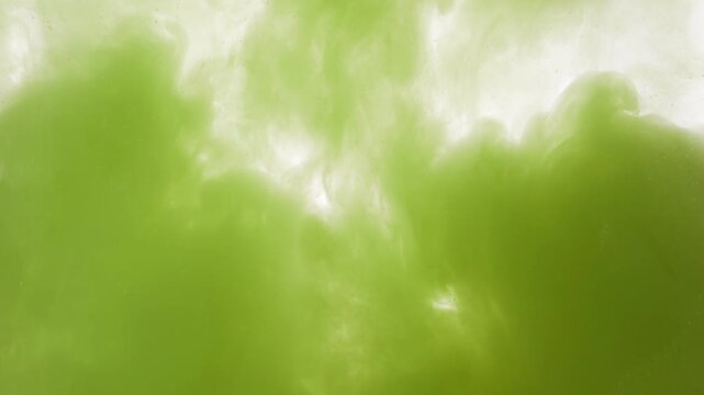 Extreme closeup of green matcha tea with fine suspended particles and swirling patterns. Flowing liquid creates abstract beverage background with soft gradients, delicate textures and vivid colors.