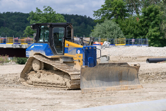 Ligny-en-Barrois, France - June 9th 2025 : View on a yellow and blue bulldozer CAT D5 for earthworks on a construction site.