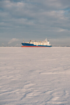 Winter shipping. Big cargo ships in frozen sea fairway