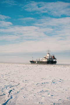 Winter shipping. Big cargo ships in frozen sea fairway