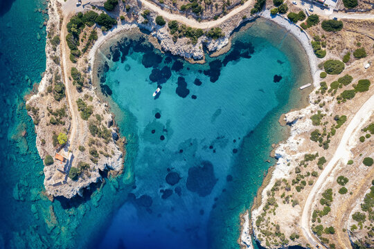 Aerial overhead view of the heart shaped Kardia beach at the island of Aegina, Saronic Gulf, Greece