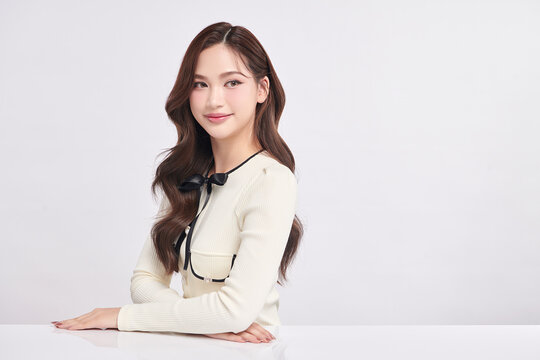 A beautiful young Asian woman with clean, fresh skin against a white background. Skincare, facial treatment, cosmetology, beauty, and spa. An elegant portrait of an Asian woman.