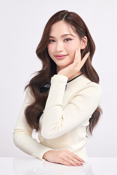 A beautiful young Asian woman with clean, fresh skin against a white background. Skincare, facial treatment, cosmetology, beauty, and spa. An elegant portrait of an Asian woman.