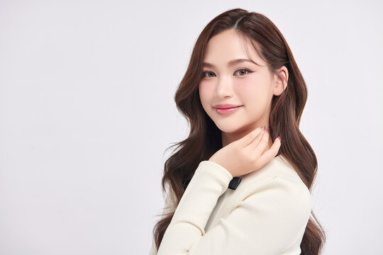 A beautiful young Asian woman with clean, fresh skin against a white background. Skincare, facial treatment, cosmetology, beauty, and spa. An elegant portrait of an Asian woman.