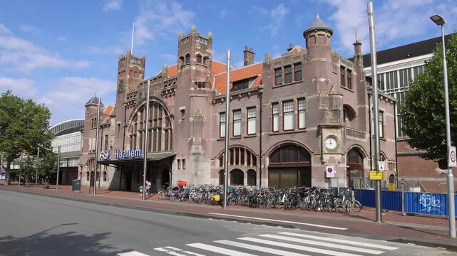Art Nouveau facade of Haarlem central train station with bicycles parked along street in Haarlem, Netherlands on 16 August 2026.