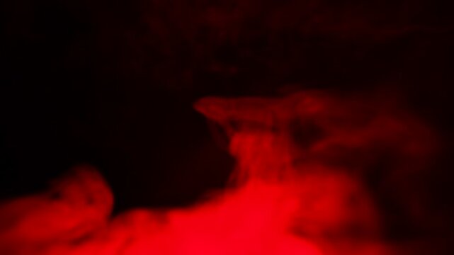 Streams of red, flowing smoke against a black background.