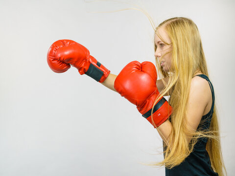 Woman in red gloves boxing