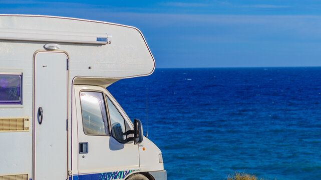 Caravan recreational vehicle camping on sea shore.