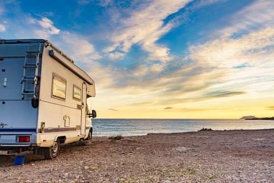 Caravan recreational vehicle camping on sea shore.