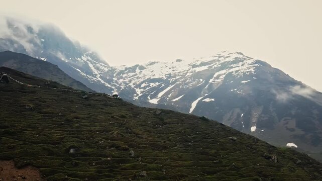 Aerial view of the dramatic snow-covered peaks of the Garhwal Himalayan range near the ancient Kedarnath temple of Uttarakhand, India.