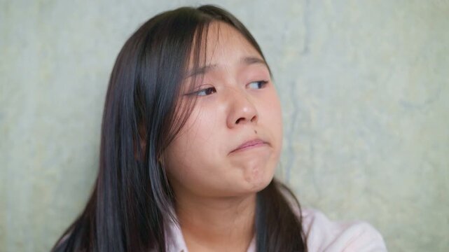 anxious worried teen girl with her smartphone as a conceptual footage for cyberbullying social media trauma, teenager mental health crisis, depression and panic attack